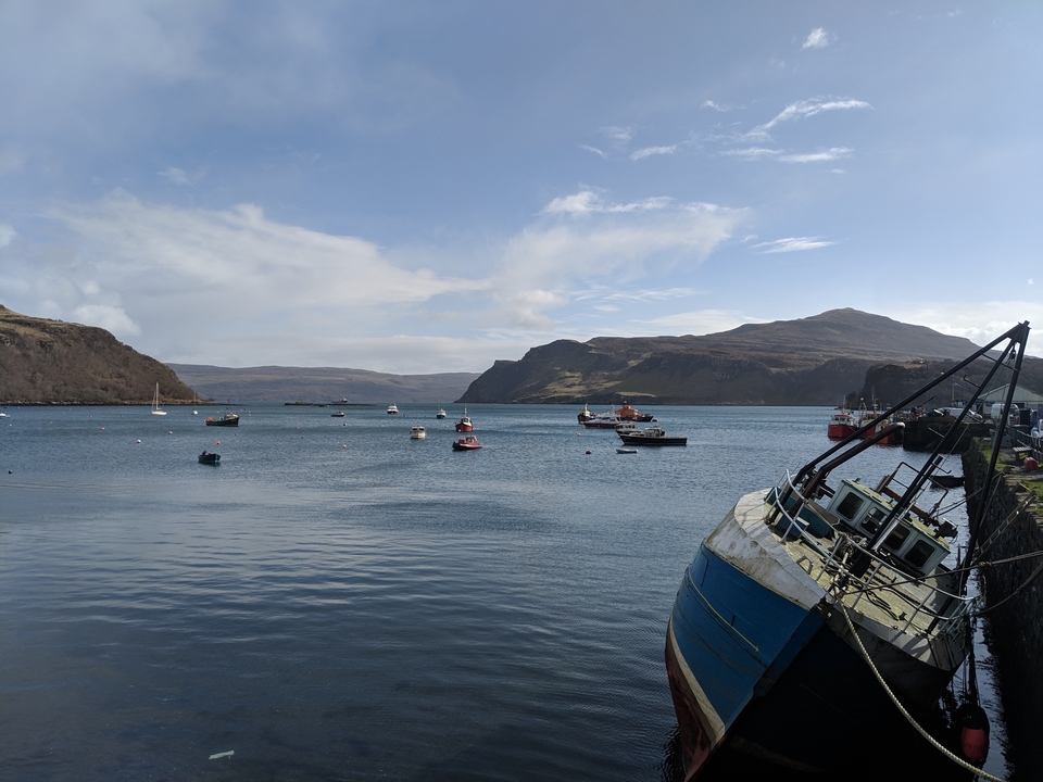 Scenic view of boats in a bay with mountains in the background.