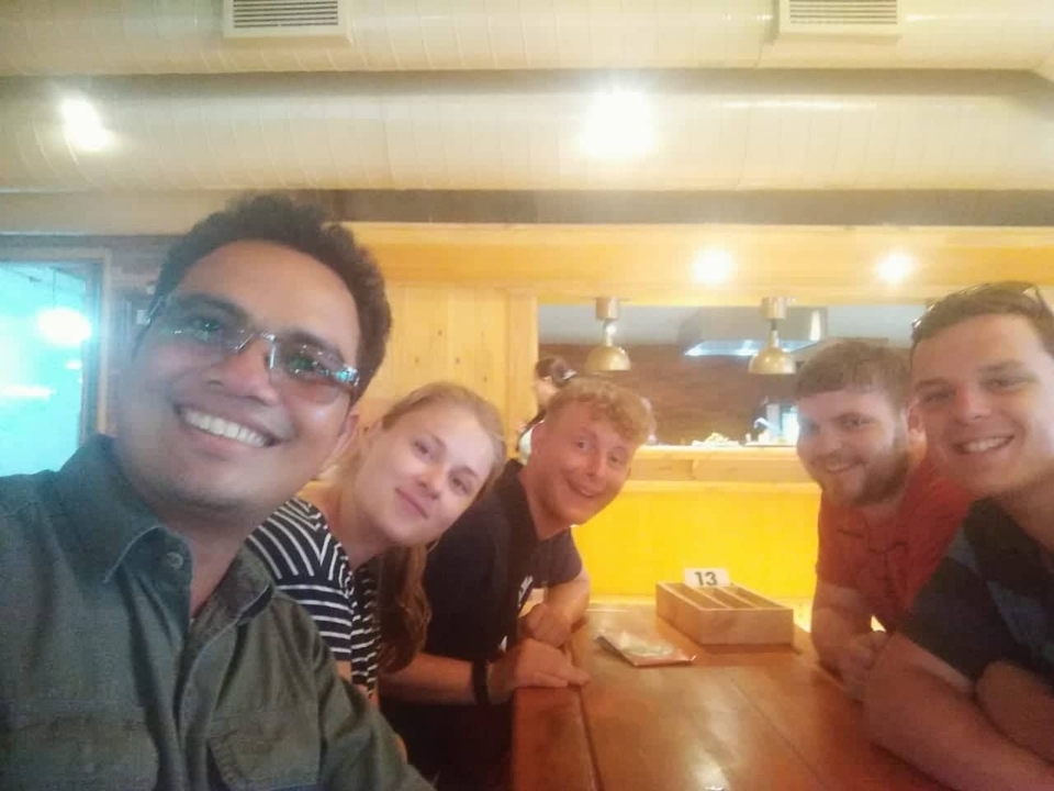 Group of people sitting indoors at a restaurant.