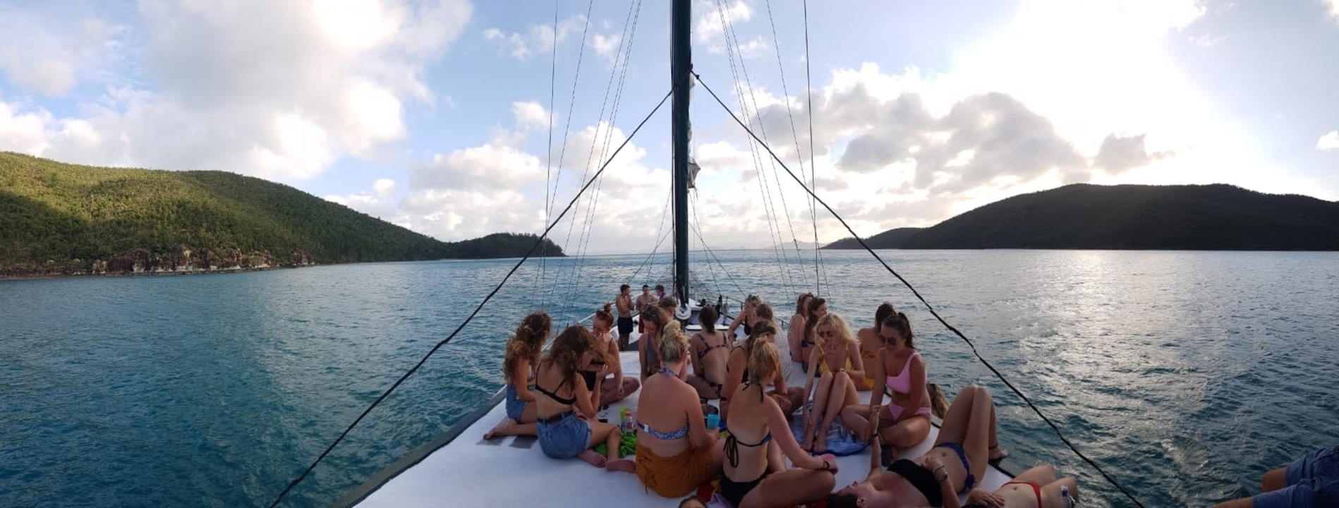 Group of people dressed up and partying in a colorful setting.