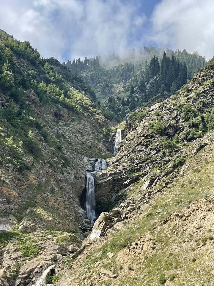 Waterfalls cascading down a rocky cliffside.