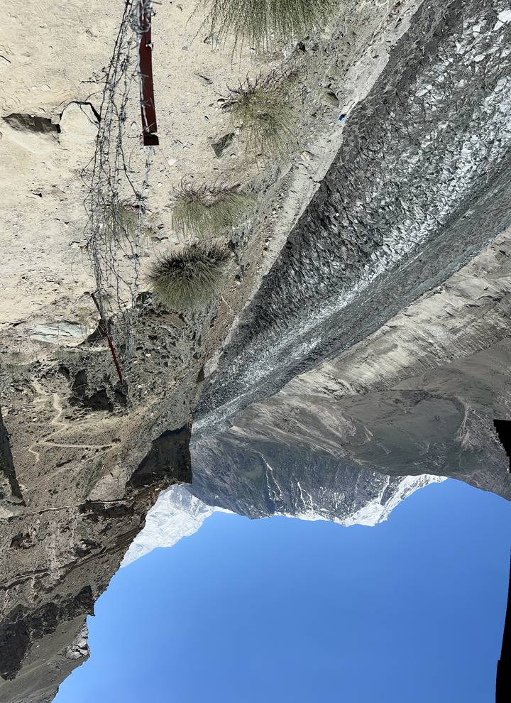 View of a glacier against a clear blue sky.