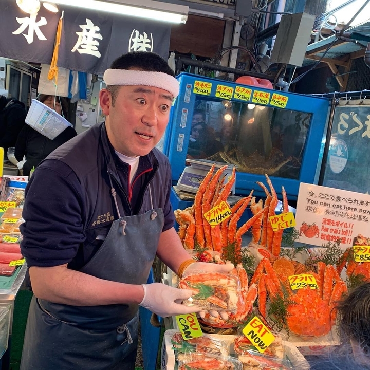 A market vendor showing fresh seafood.