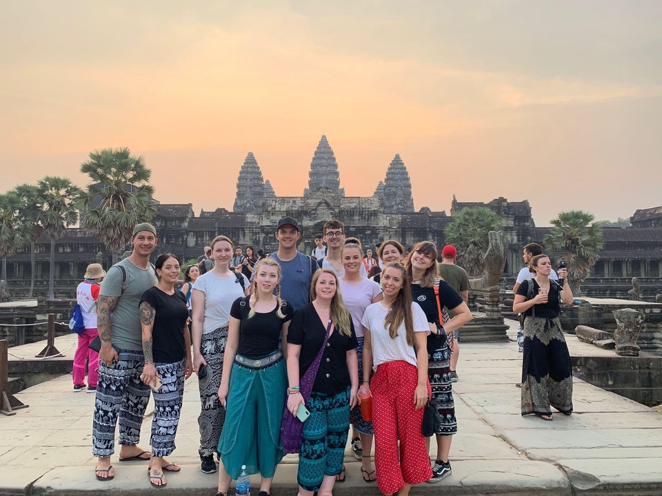 Group of people in front of Angkor Wat temple.