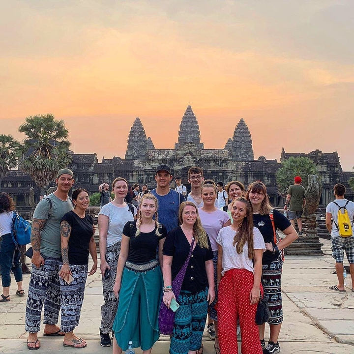 Group of people in front of Angkor Wat temple.