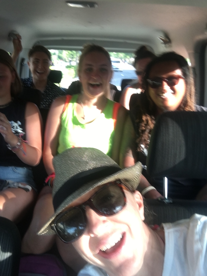 Blurry group photo inside a vehicle.
