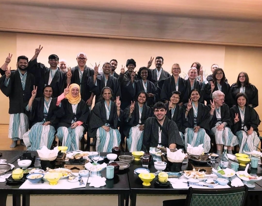Group of people in traditional clothing posing for a photo.