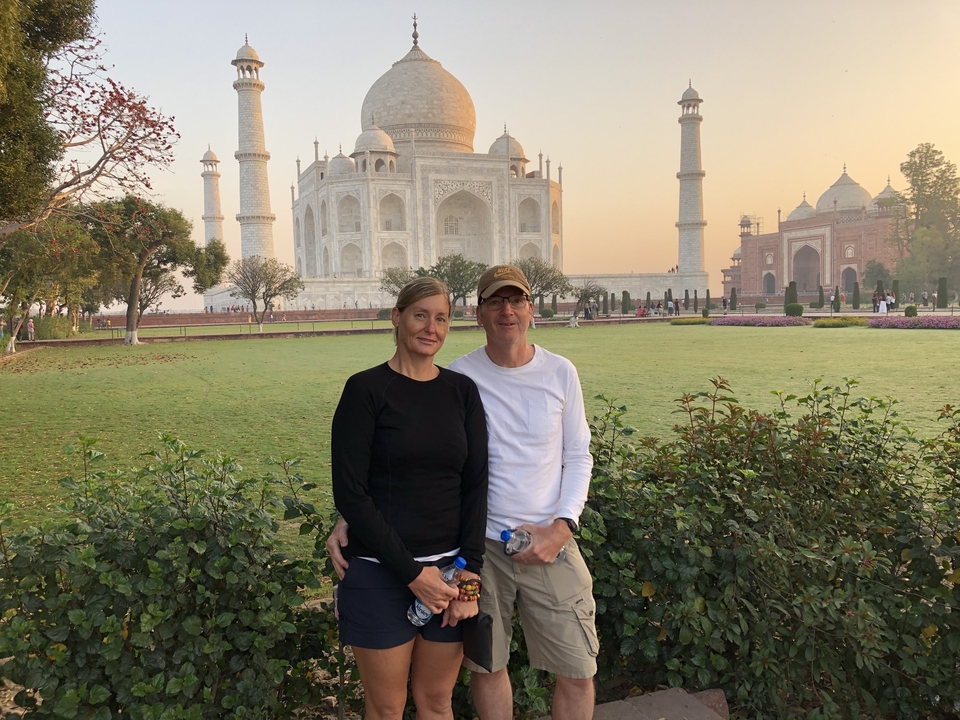 Two people posing in front of the Taj Mahal.