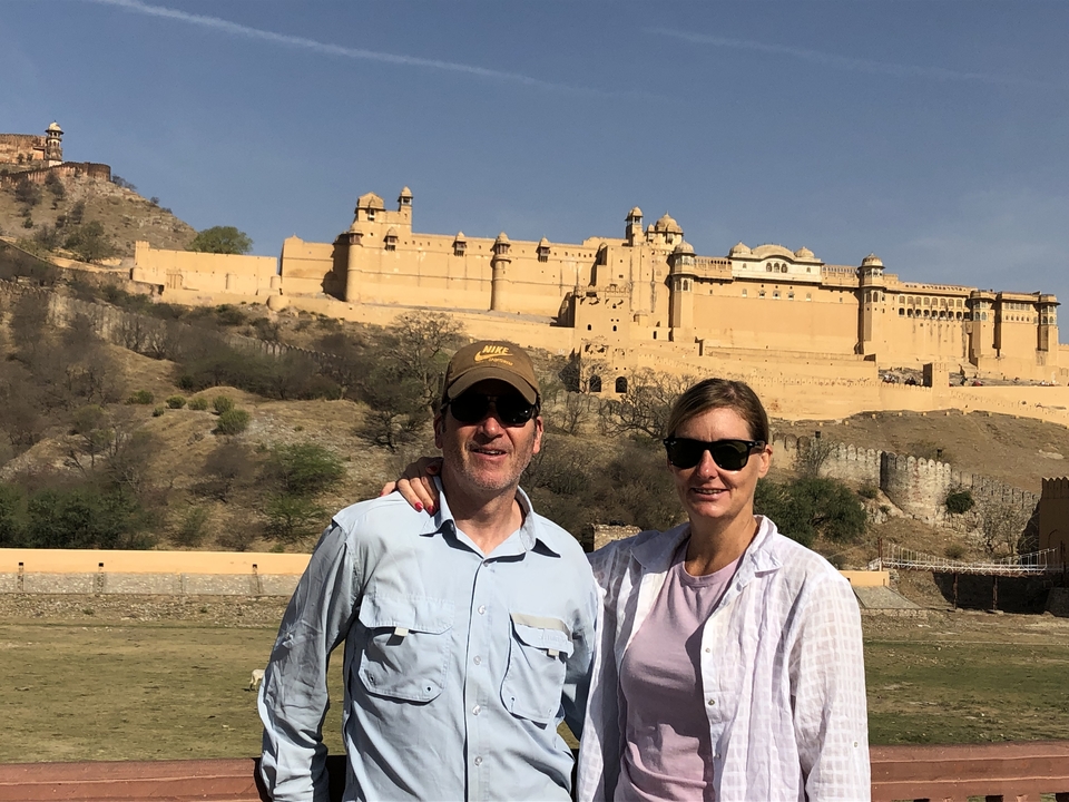 Two people with Amer Fort in the background.