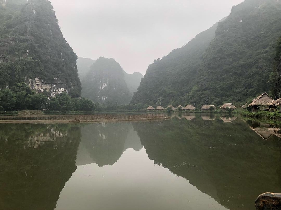 Mist-covered mountains and lake.