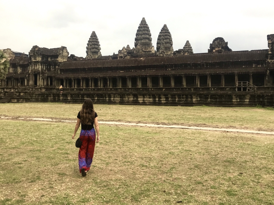 Person walking towards Angkor Wat.