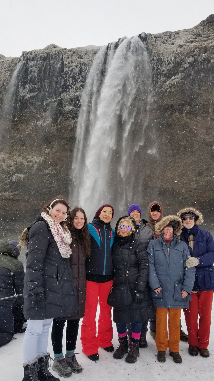People posing in front of a waterfall