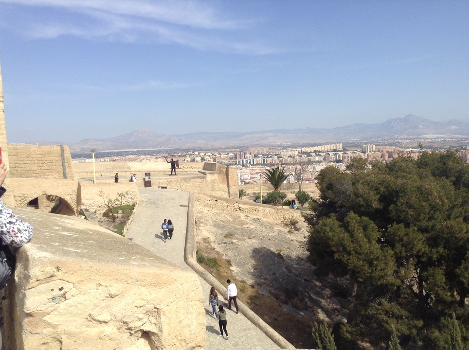 View from a fortress overlooking a city and distant mountains.