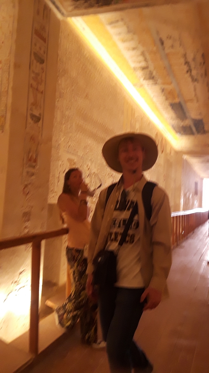 Blurry image of people in an illuminated hallway.