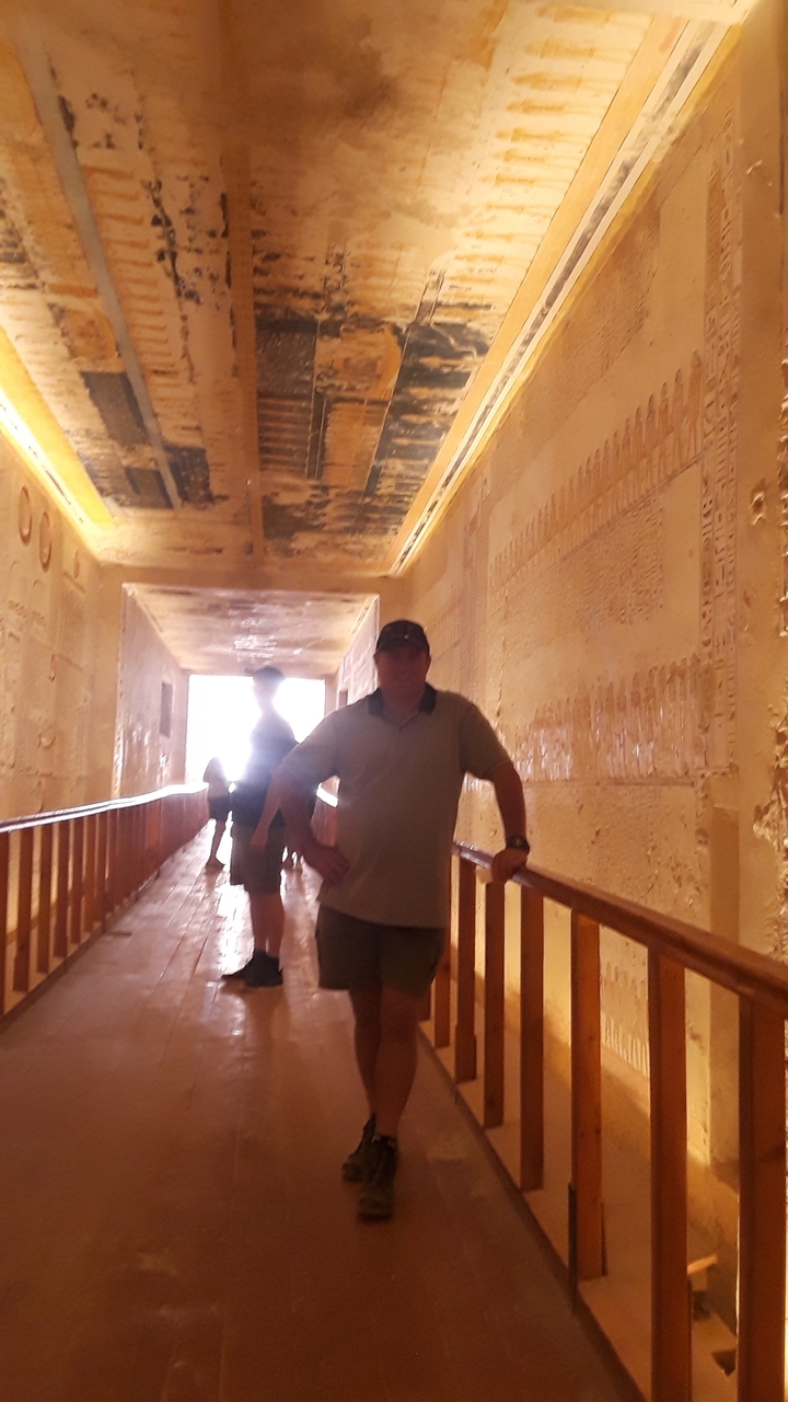 Blurry image of tourists in an ancient hallway.