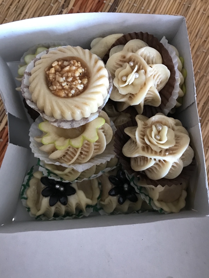 Box of intricately designed pastries.
