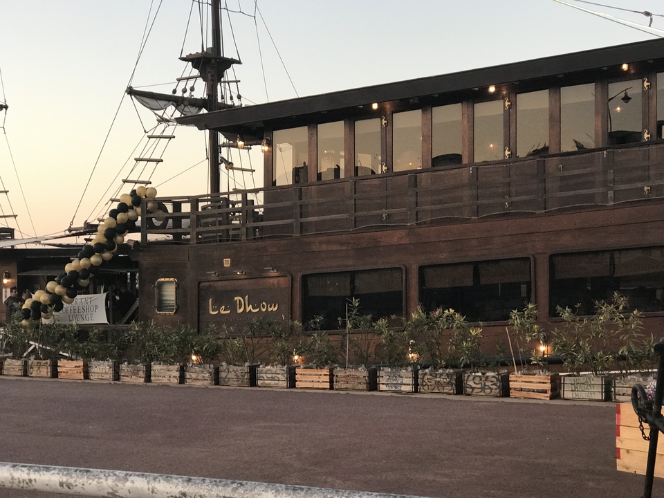 A wooden ship-themed restaurant with a decorated exterior.