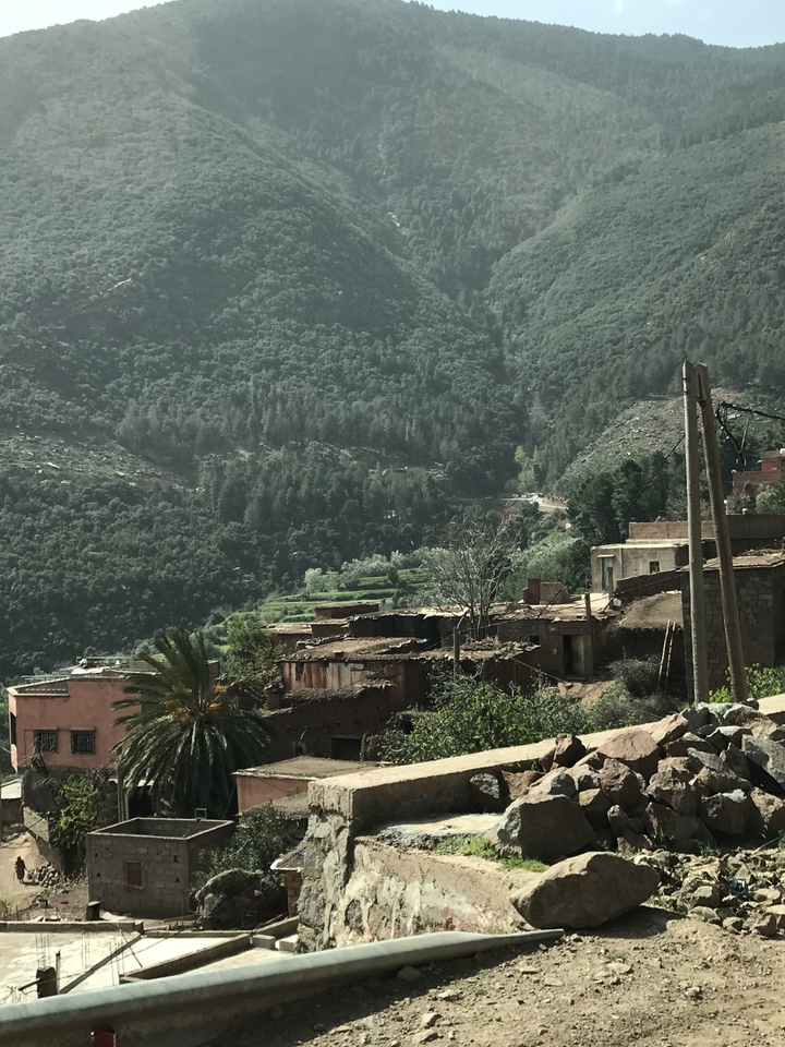 Village on a hillside with lush greenery.