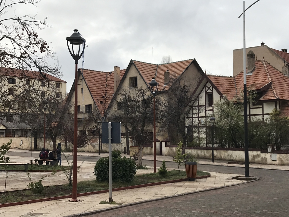 Street view with people sitting and traditional architecture.