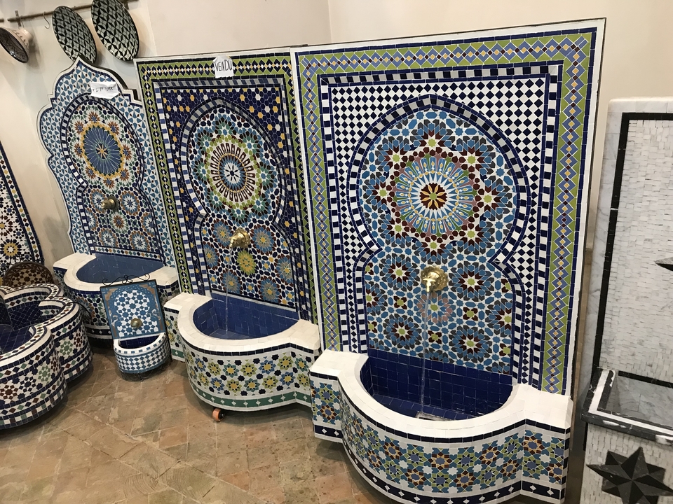 Colorful mosaic fountains on display with intricate designs.
