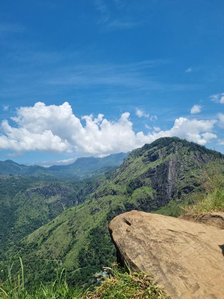 Panoramic view of a mountain landscape with clouds.