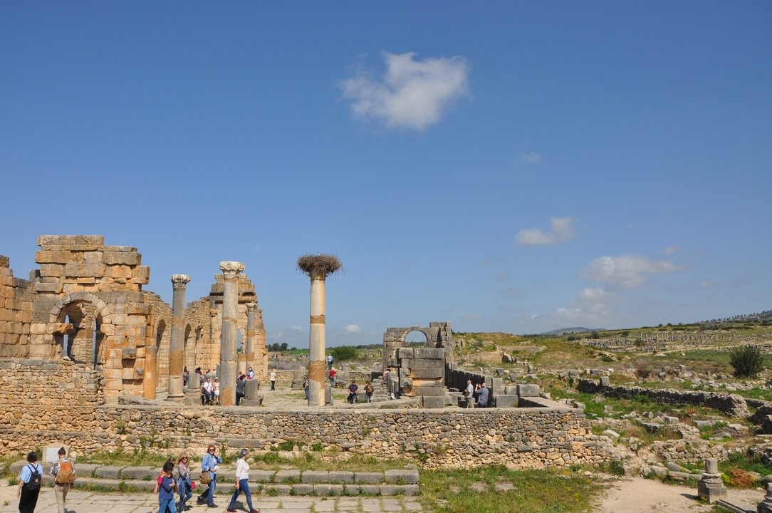 Roman ruins with columns and people walking