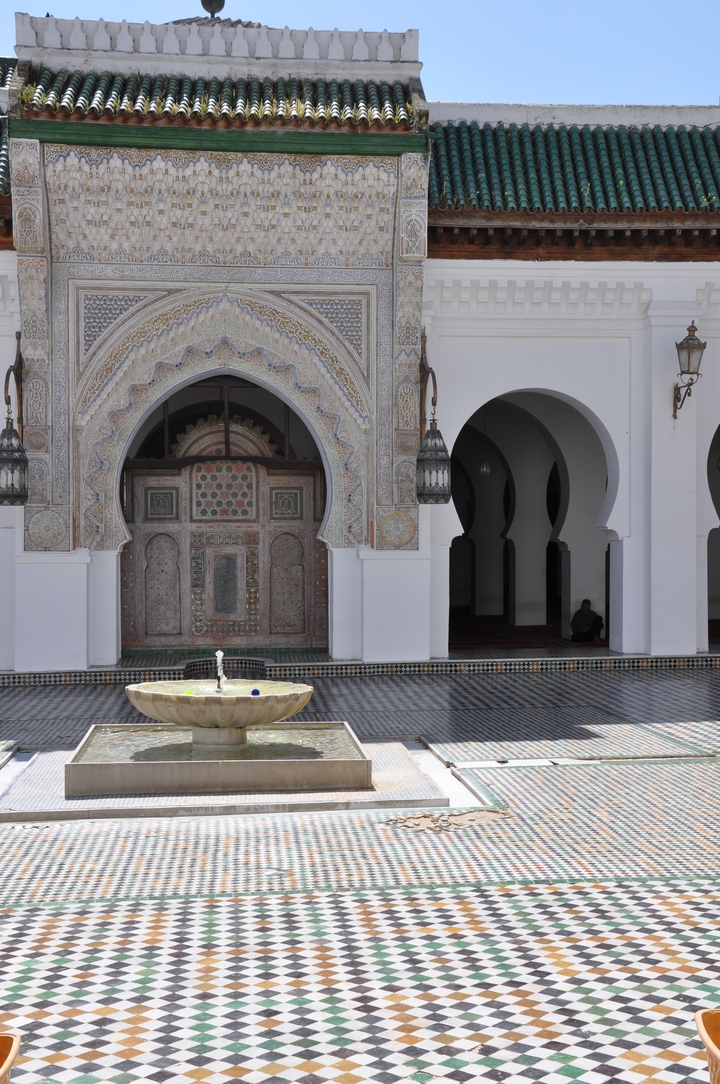 Arched entrance with a fountain in a courtyard