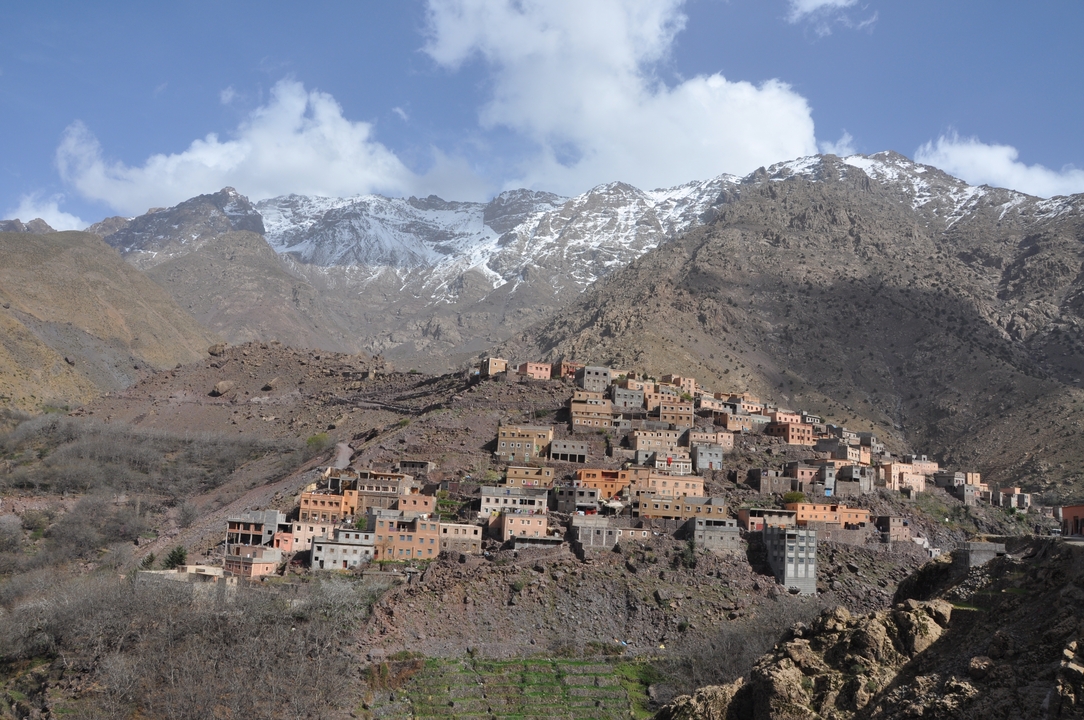 Mountain village with snow-capped peaks in the background