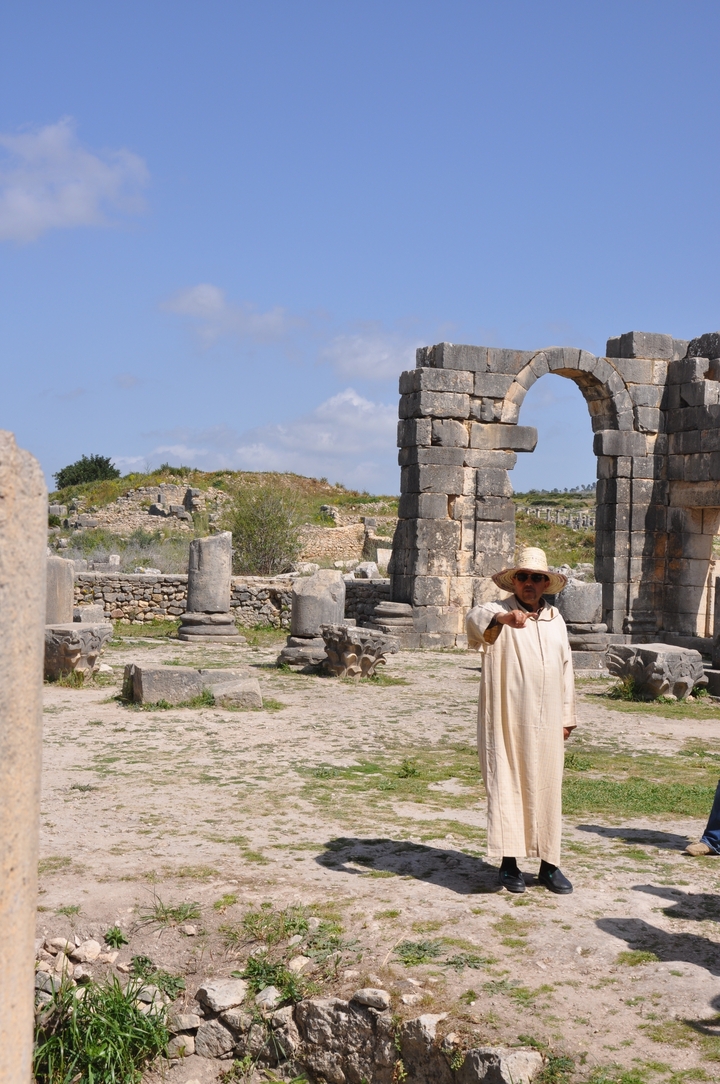 Ancient ruins with a guide speaking to visitors
