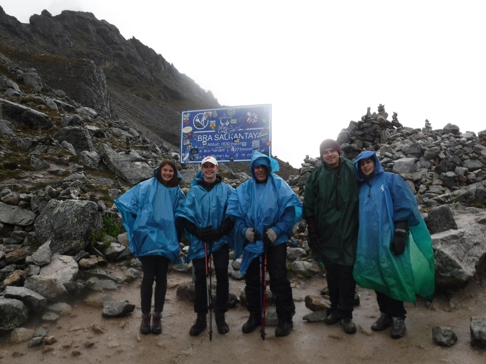 Group of hikers in blue rain ponchos at Salkantay Mountain.