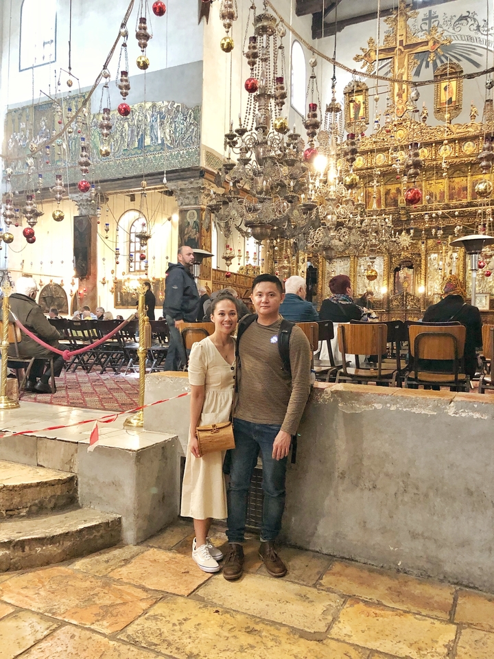 Couple inside an ornate religious building.