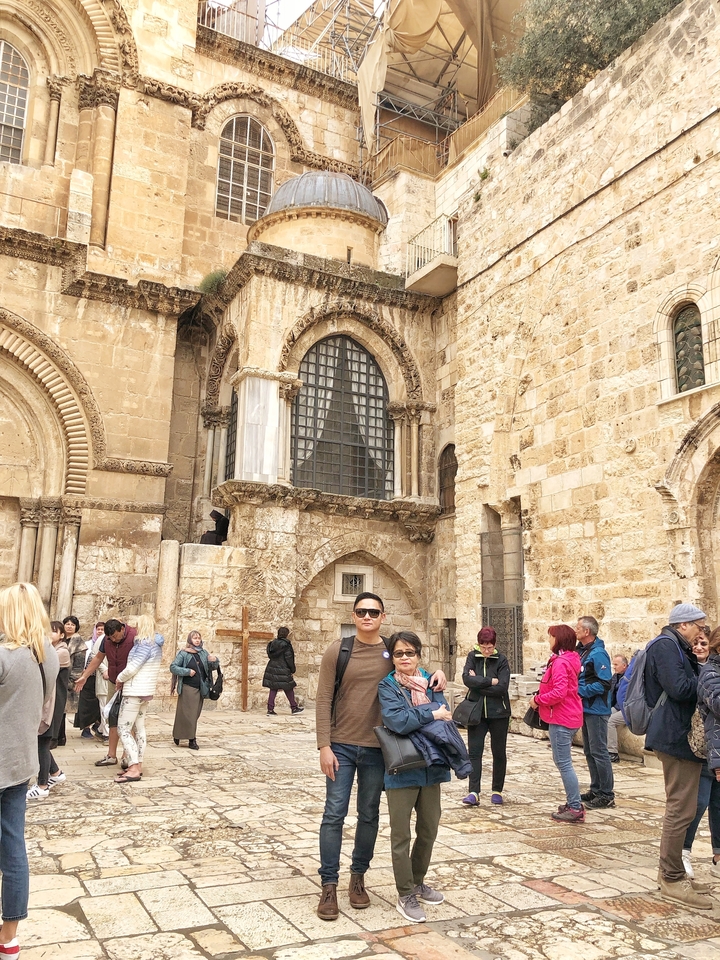 Tourists at an ancient stone wall.