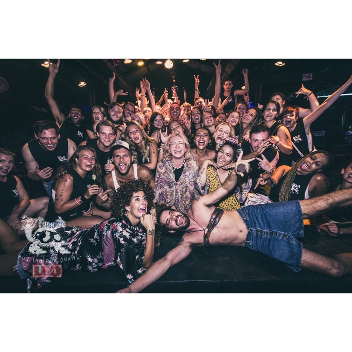 Group of people enjoying a night out with lively expressions.