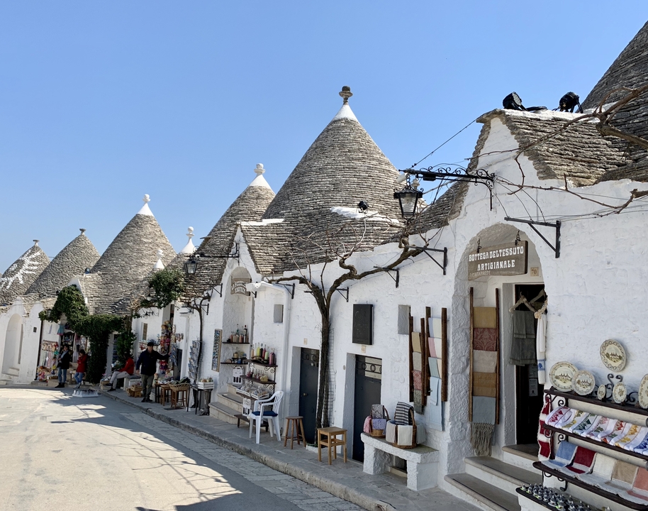 Row of conical-roofed houses on a sunny day.
