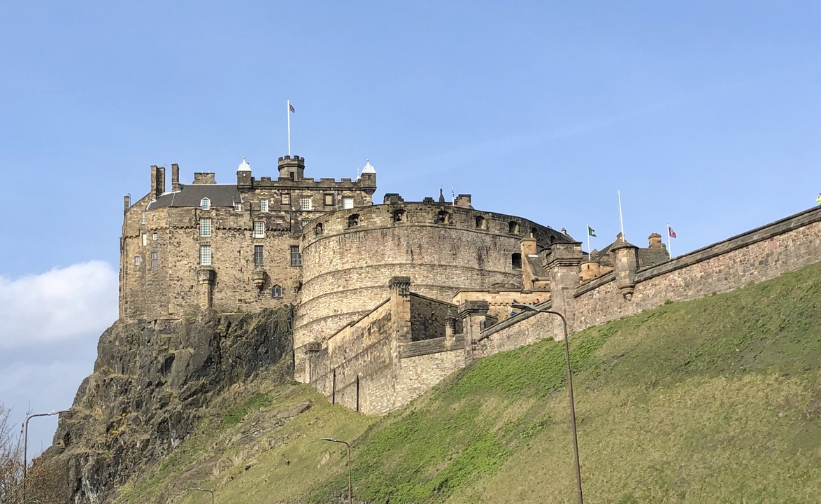 Castle fortress on a hill under a blue sky.