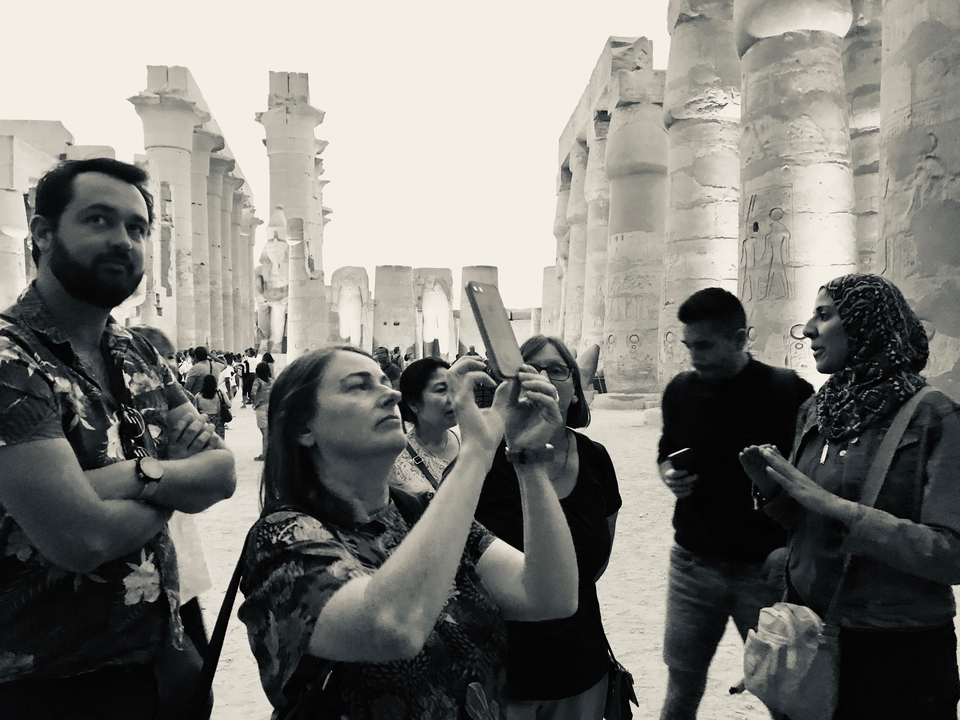 Group of people exploring ancient ruins.