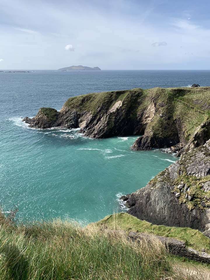 Cliffs with turquoise water and waves crashing