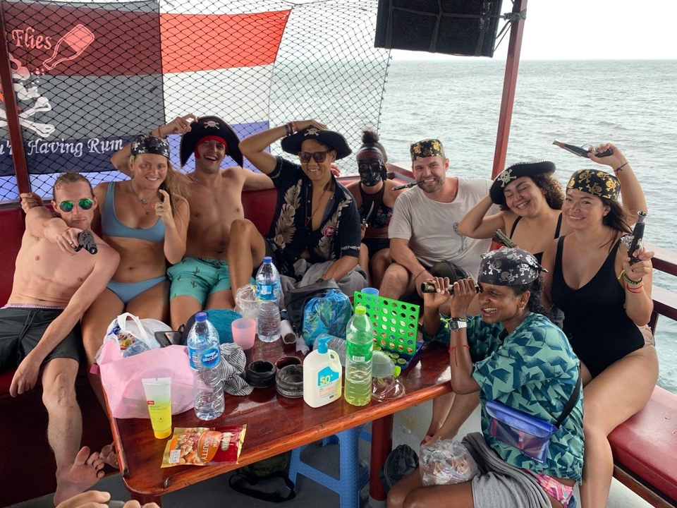 Group of people in pirate attire on a boat.