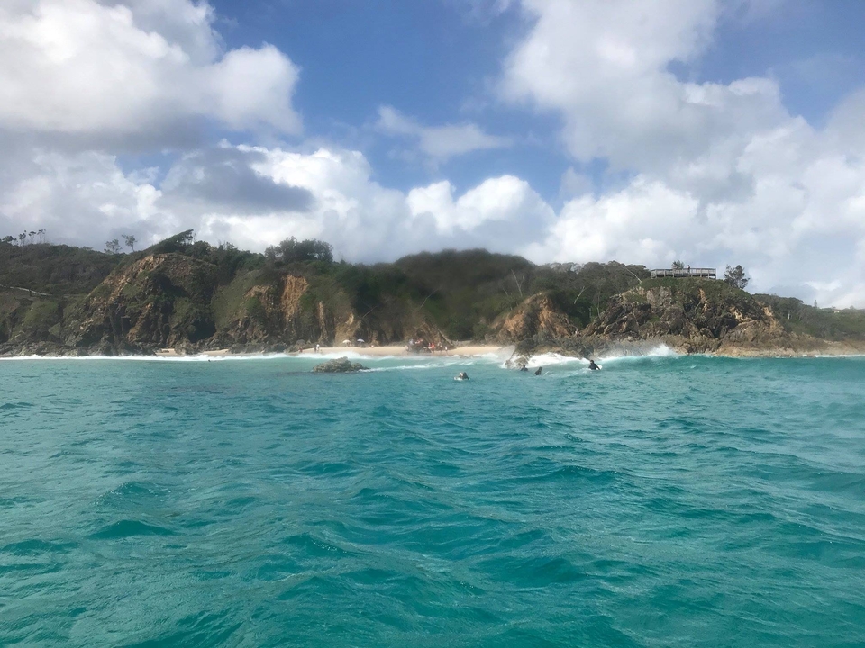 Scenic coastline with waves crashing against rocks.