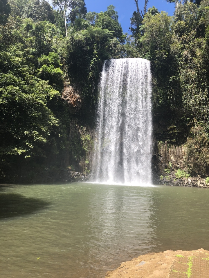 A powerful waterfall cascading into a pool below.