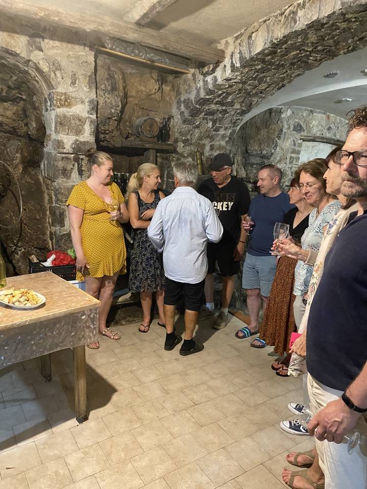 People gathered in a room with stone walls.