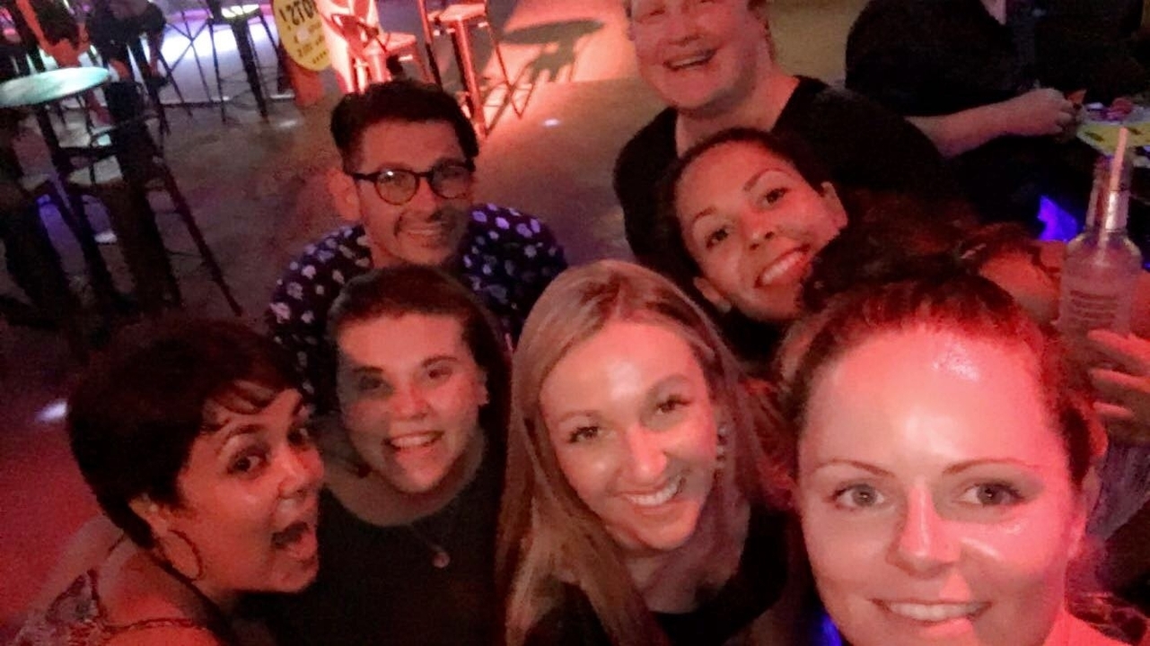 Group of people enjoying nightlife in a bar or club.