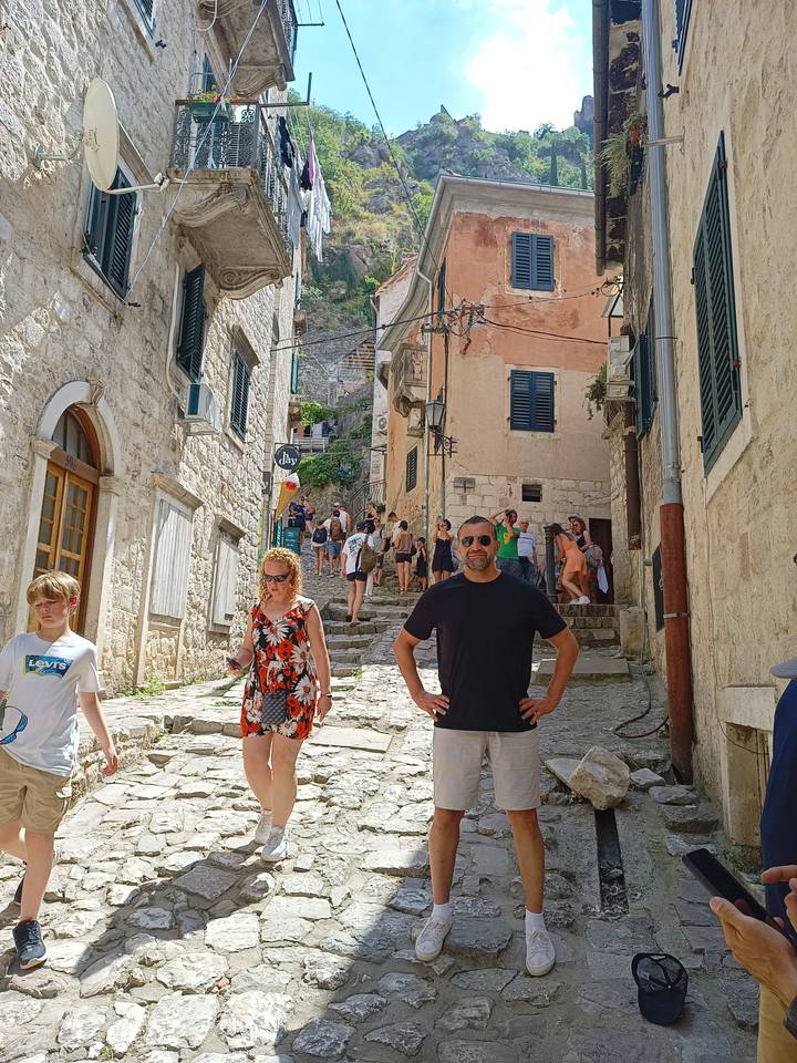 A couple standing in an ancient stone street.