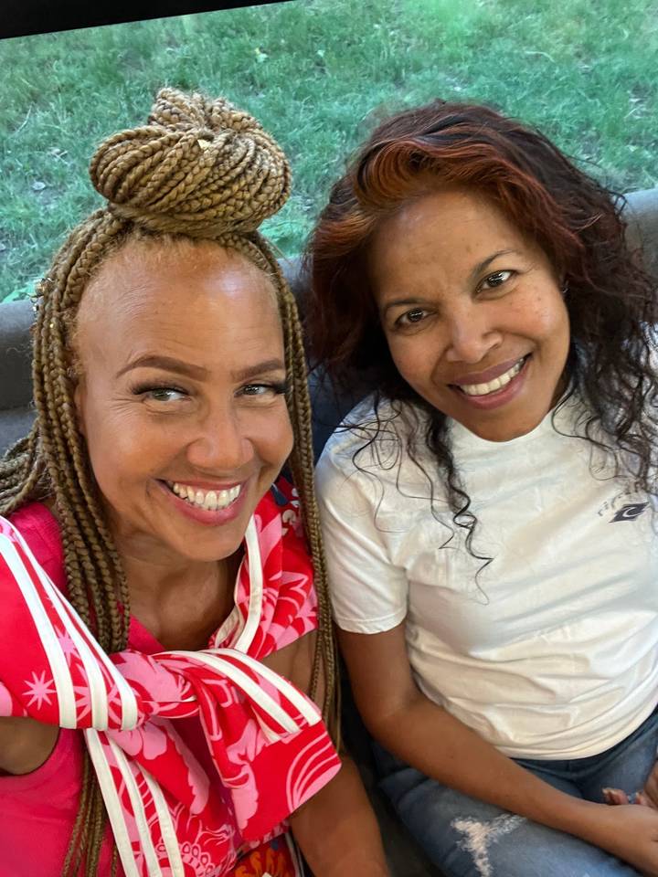 Two women smiling together.