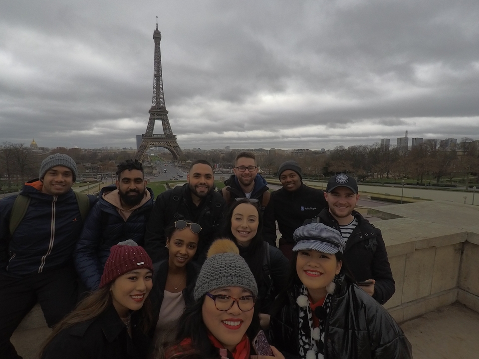 Group posing in front of the Eiffel Tower.
