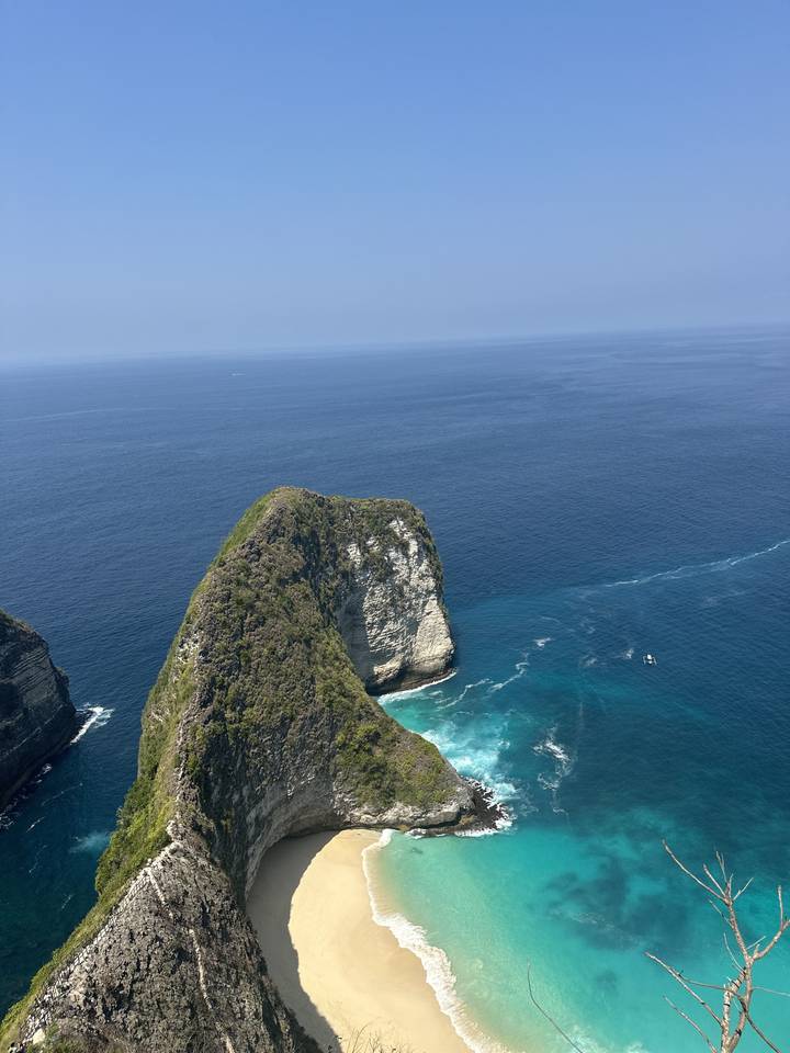 A coastline view with a prominent cliff and beach.