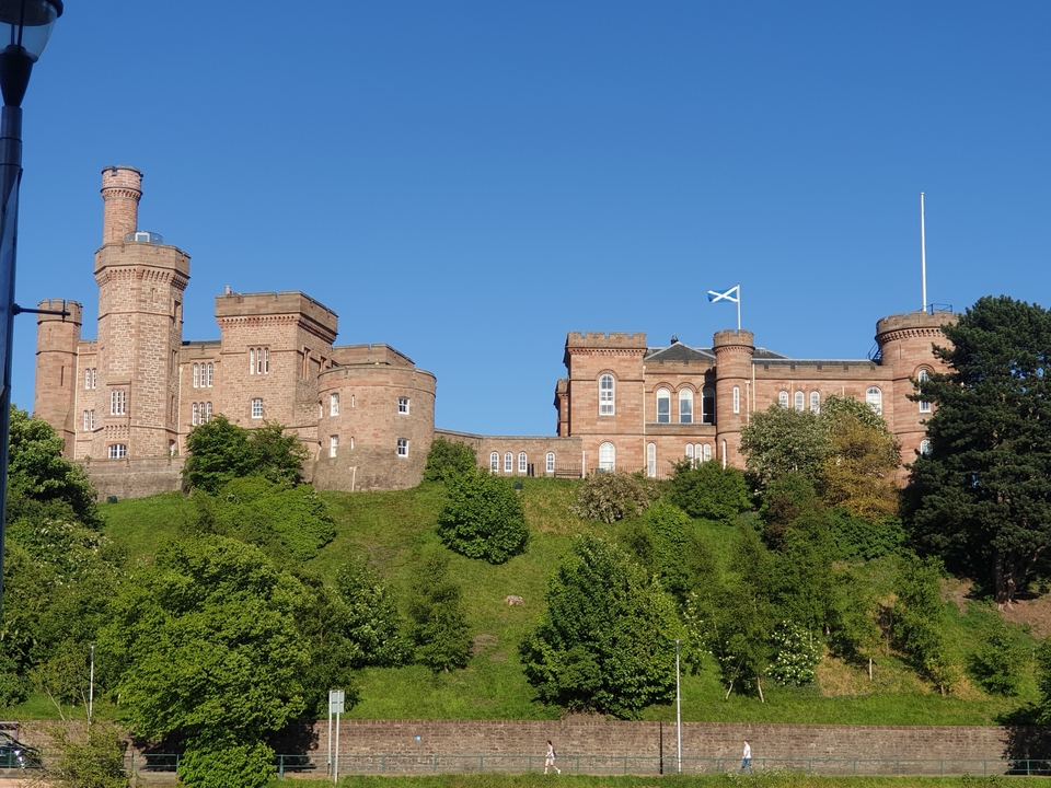 Castle on a hill with trees below.