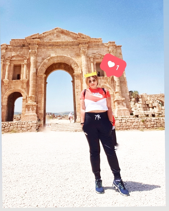 Person posing in front of an ancient archway with digital overlay.
