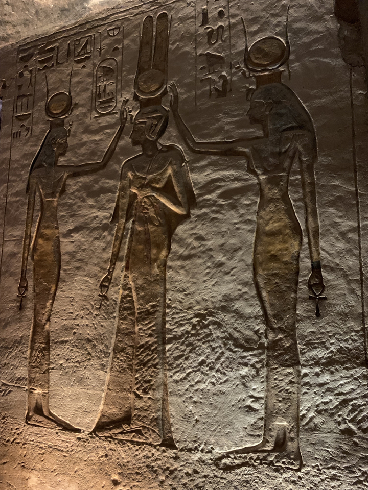 Carving of Egyptian figures on wall.