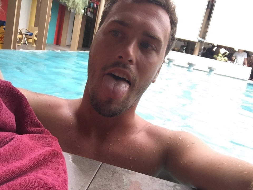 A selfie of a person in a pool.