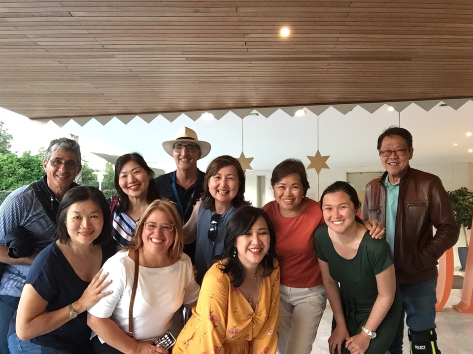 Group of people smiling for a photo indoors.